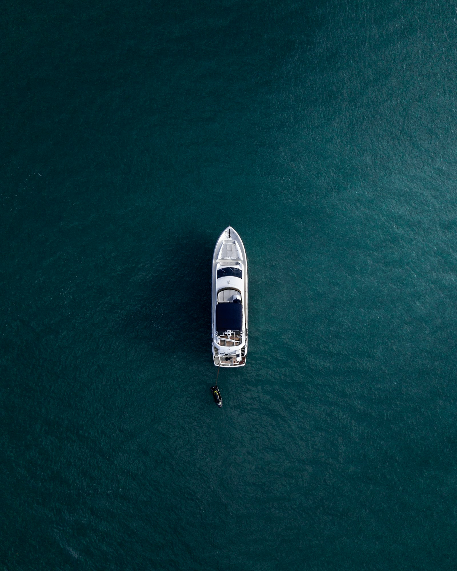 Aerial view of a superyacht on calm turquoise water